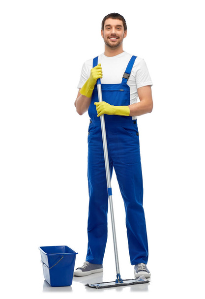 male cleaner cleaning floor with mop and bucket - Foto, Imagen
