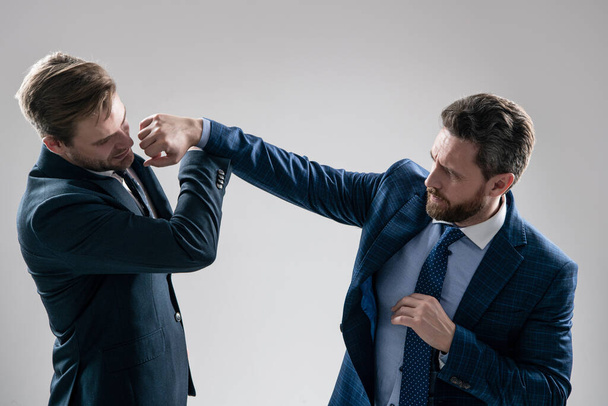 two angry businessmen punching in fight and arguing having struggle for leadership on businessmeeting because of business competition, business knockout. - Photo, Image