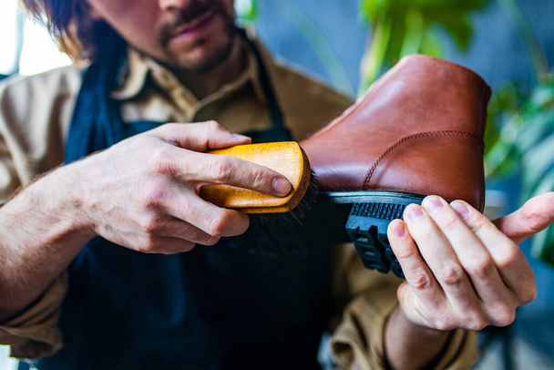 skilled shoemaker make a leather shoes in workshop - Valokuva, kuva