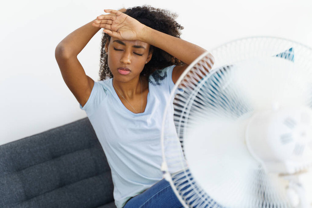 Black young woman suffering a heat wave at home - Photo, Image