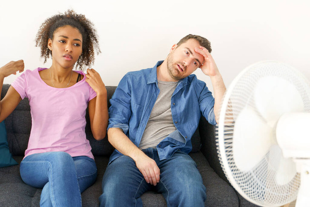 Mixed race couple trying to relief from summer heat wave - Photo, Image