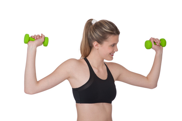 Fitness - Young sportive woman exercise with weights - Foto, Bild