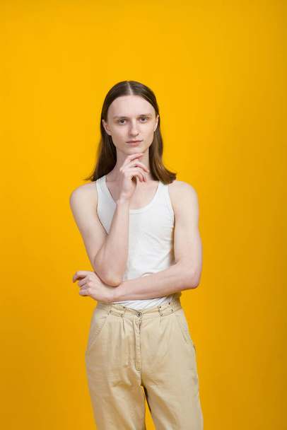 Androgynous beautiful young man. Model tests in yellow background - Foto, Imagem
