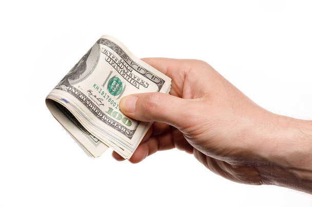 Hand houden van geld met honderd dollar bankbiljetten geïsoleerd op een witte achtergrond - Foto, afbeelding