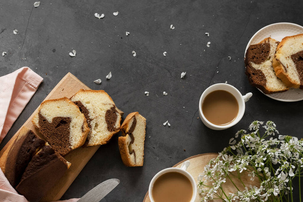 Delicious homemade marble pound cake and milk coffee - Foto, afbeelding