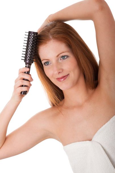 Young woman doing hair on white background - Photo, Image