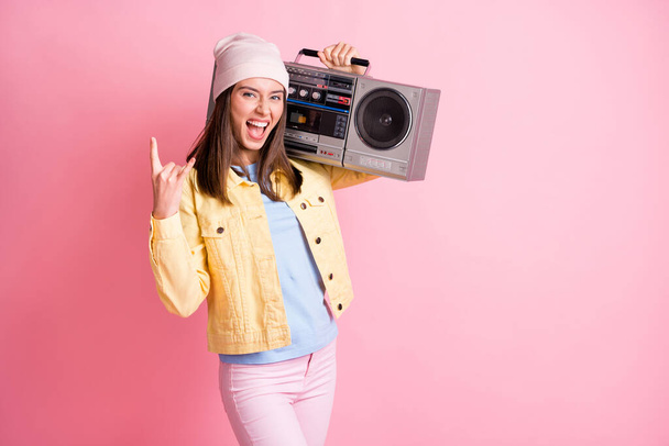 Photo of young crazy attractive woman girl female showing rock n roll sign hold boombox on shoulders isolated on pink color background - Fotoğraf, Görsel