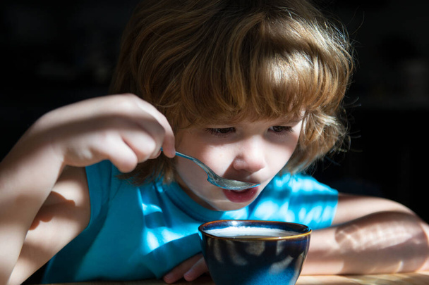 Pequeno-almoço saboroso para crianças. Comida caseira saudável. O rapaz come na cozinha. Nutrição para crianças. - Foto, Imagem