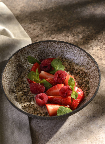 porridge with strawberries raspberries and chia - Fotoğraf, Görsel