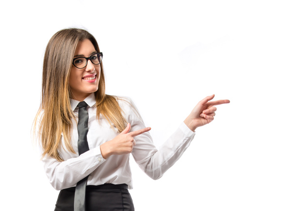 Young pretty businesswoman pointing over white background  - Photo, Image