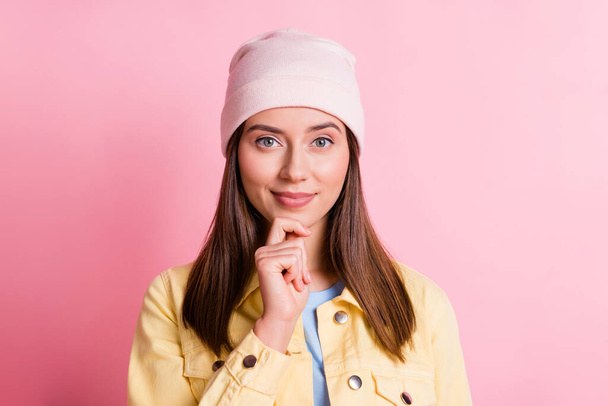 Photo of cute lovely young woman dressed casual clothes cap thinking finger chin isolated pink color background - Foto, Imagen