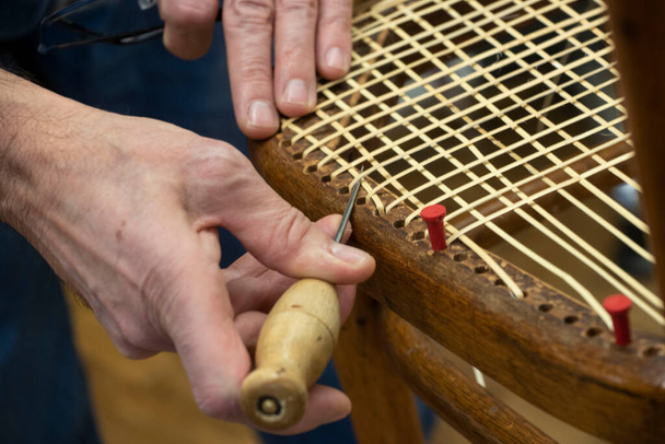 basket weaving in a sheltered workshop, work with disabled or handicapped people - Fotó, kép