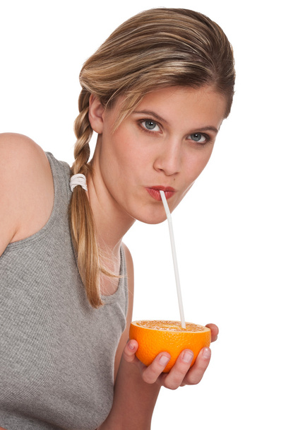 Woman drinking orange on white background - Zdjęcie, obraz