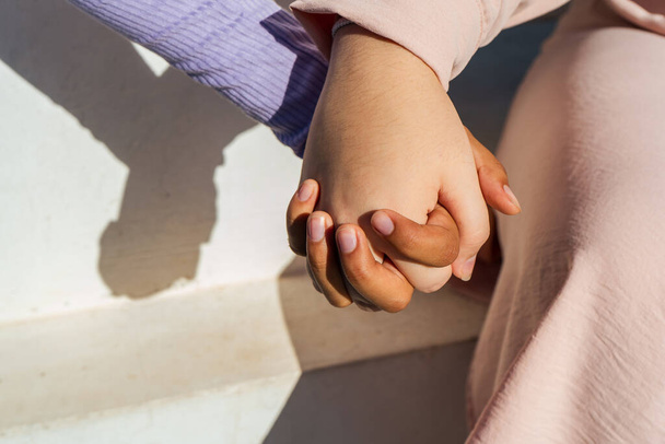 Young ladies holding hands showing their feelings. - Photo, image