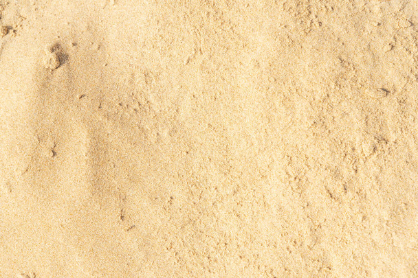 Homok textúra háttér a strandon. Világos bézs tenger homok textúra minta, homokos strand háttér. - Fotó, kép