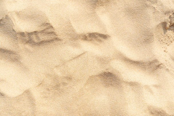 Sand texture background on the beach. Light beige sea sand texture pattern, sandy beach background. - Photo, image