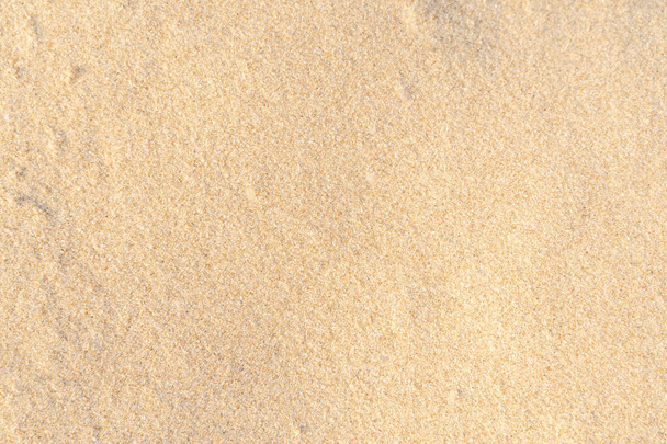 Sand texture background on the beach. Light beige sea sand texture pattern, sandy beach background. - Foto, afbeelding