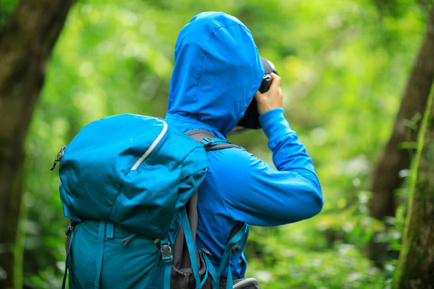 Woman photographer taking photo  in spring forest - Photo, image