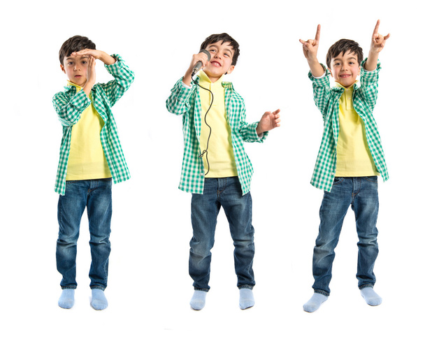 dziecko śpiewa, wykonując gest limitu czasu i Dokonywanie znak róg - Zdjęcie, obraz
