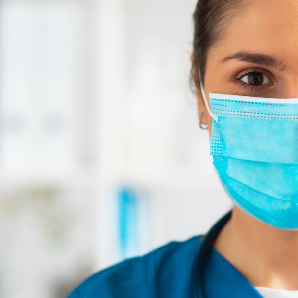 Professional medical doctor working in hospital office, Portrait of young and attractive female physician in protective mask. - Fotografie, Obrázek