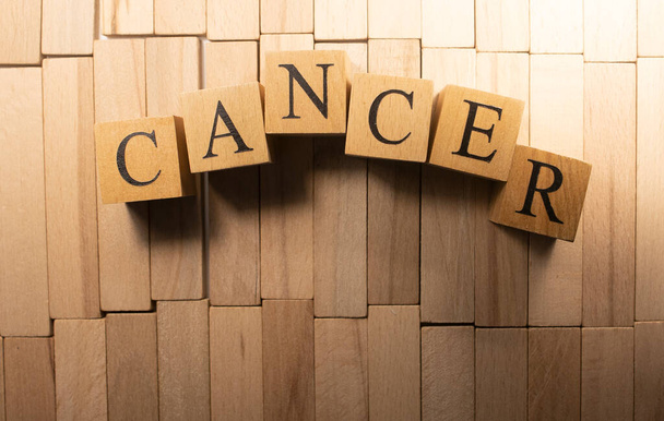 The word cancer was created from wooden cubes. Health and life - Foto, Imagen