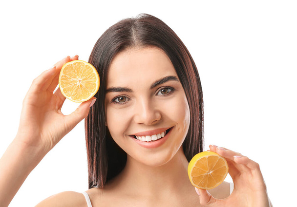 Beautiful young woman with lemons on white background - Zdjęcie, obraz