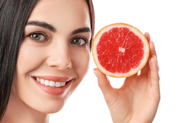 Beautiful young woman with grapefruit on white background, closeup - Фото, зображення