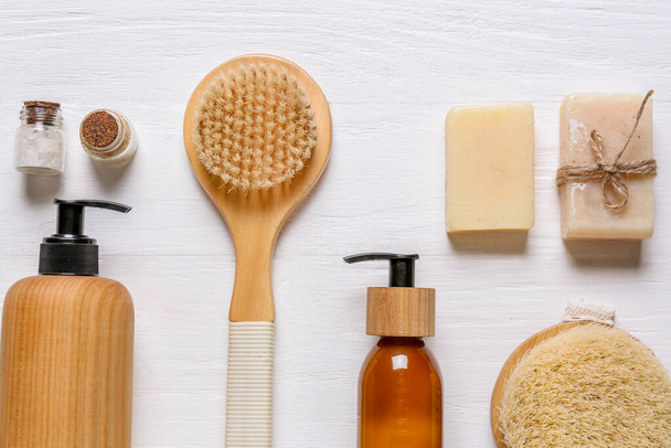 Composition with massage brushes and bath supplies on light wooden background - Φωτογραφία, εικόνα