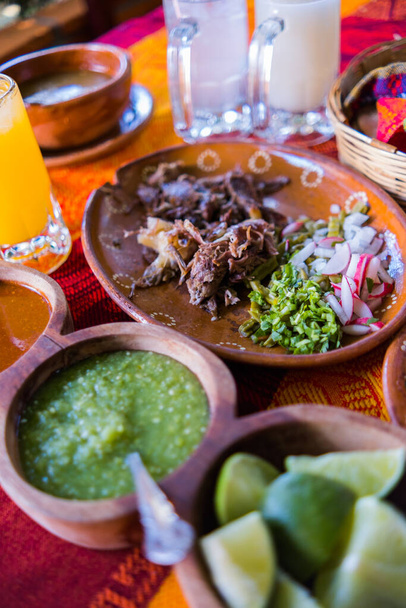 Mexican chopped lamb meat, condiments, and two jars of refreshing drink - Photo, Image