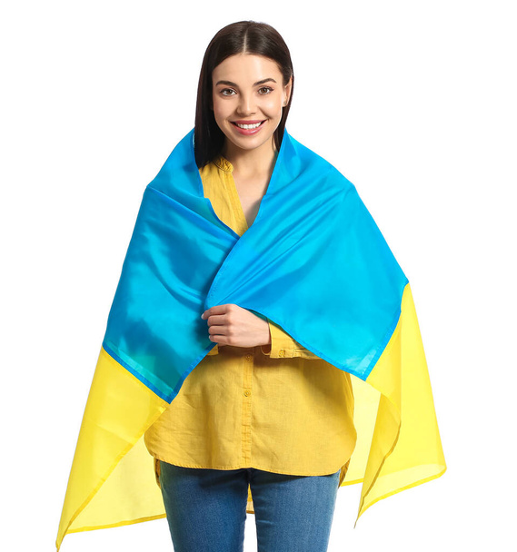 Beautiful young woman with Ukrainian flag on white background - Foto, afbeelding