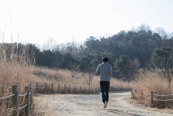 Asian man walking, strolling, jogging with mask - Fotó, kép