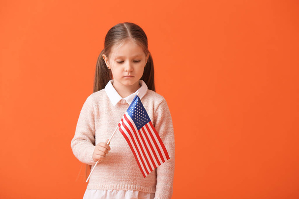 Little girl with USA flag on color background - Foto, imagen
