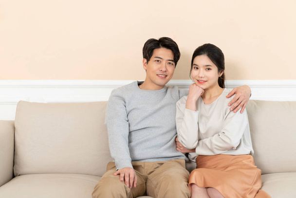 newly married Asian couple at home concept, sitting on sofa - Foto, immagini