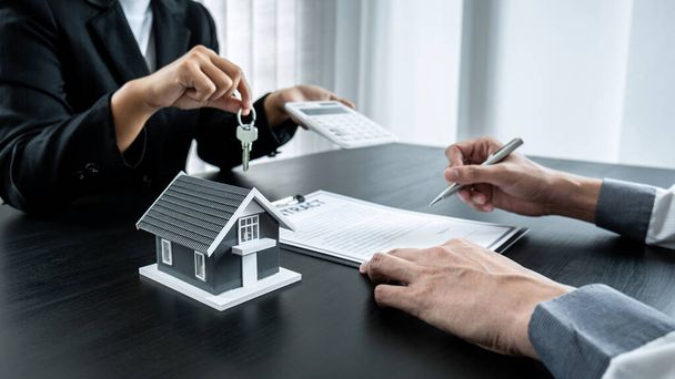 Агент з нерухомості надає будинку та ключі клієнту після підписання договору оренди нерухомості з затвердженою заявою про іпотеку для або страхування будинку
. - Фото, зображення