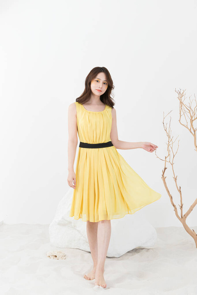 beautiful Asian model in yellow dress, spring beauty concept - Foto, imagen