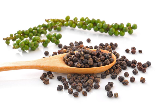 Spoon with Whole Black Pepper Granules and Bunches of fresh gree - Photo, Image