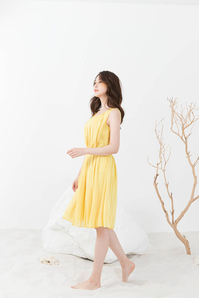 beautiful Asian model in yellow dress, spring beauty concept - Foto, immagini