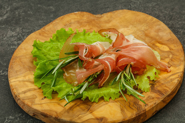 Sliced pork Jamon meat with rosemary - Фото, изображение
