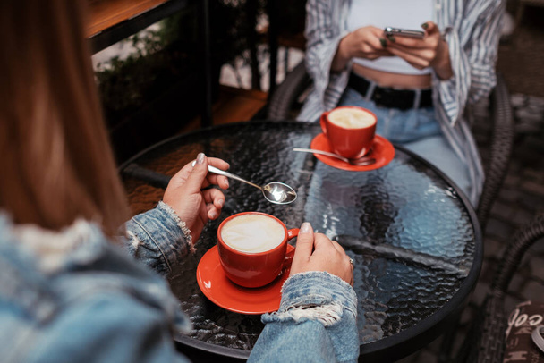 Two Women Friends Drinking Coffee in a Cafe Outdoors, Lunch Time Concept - Photo, Image