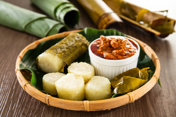 Lemang. Glutinous rice is wrapped with lerek or banana leaf encased in bamboo culm and cooked in open fire. - Photo, Image