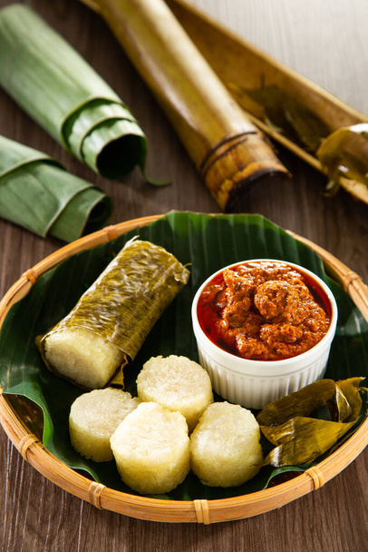 Lemang. Glutinous rice is wrapped with lerek or banana leaf encased in bamboo culm and cooked in open fire. - Photo, Image