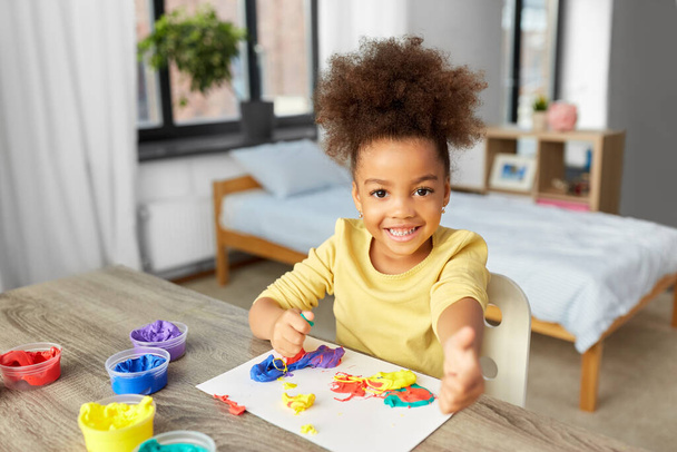 little girl with modeling clay playing at home - Photo, image