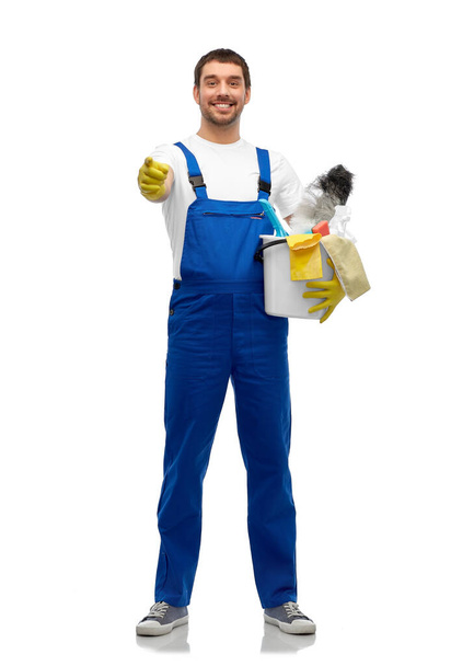 male cleaner in overall with cleaning supplies - Fotoğraf, Görsel