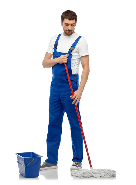 male cleaner cleaning floor with mop and bucket - 写真・画像