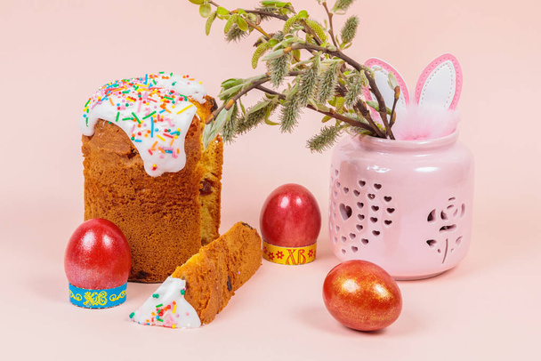 Easter. Easter cakes with eggs and bunny ears on a pink background. Easter. Vase with flowering branches. - Valokuva, kuva