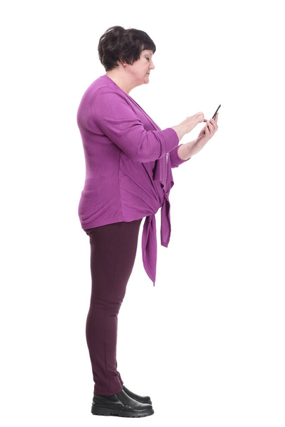 in full growth.casual an elderly woman with a smartphone. - Photo, image