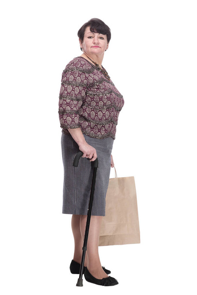 elderly woman with a walking stick and shopping bags. - Foto, Imagem