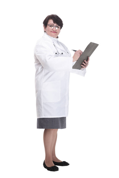 in full growth. senior female doctor with a clipboard. - Fotó, kép