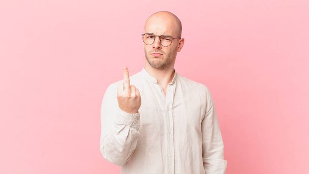 bald man feeling angry, annoyed, rebellious and aggressive, flipping the middle finger, fighting back - Photo, Image