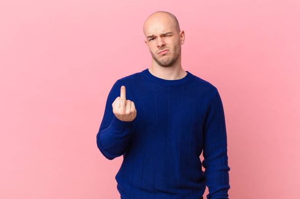 bald man feeling angry, annoyed, rebellious and aggressive, flipping the middle finger, fighting back - Foto, Bild